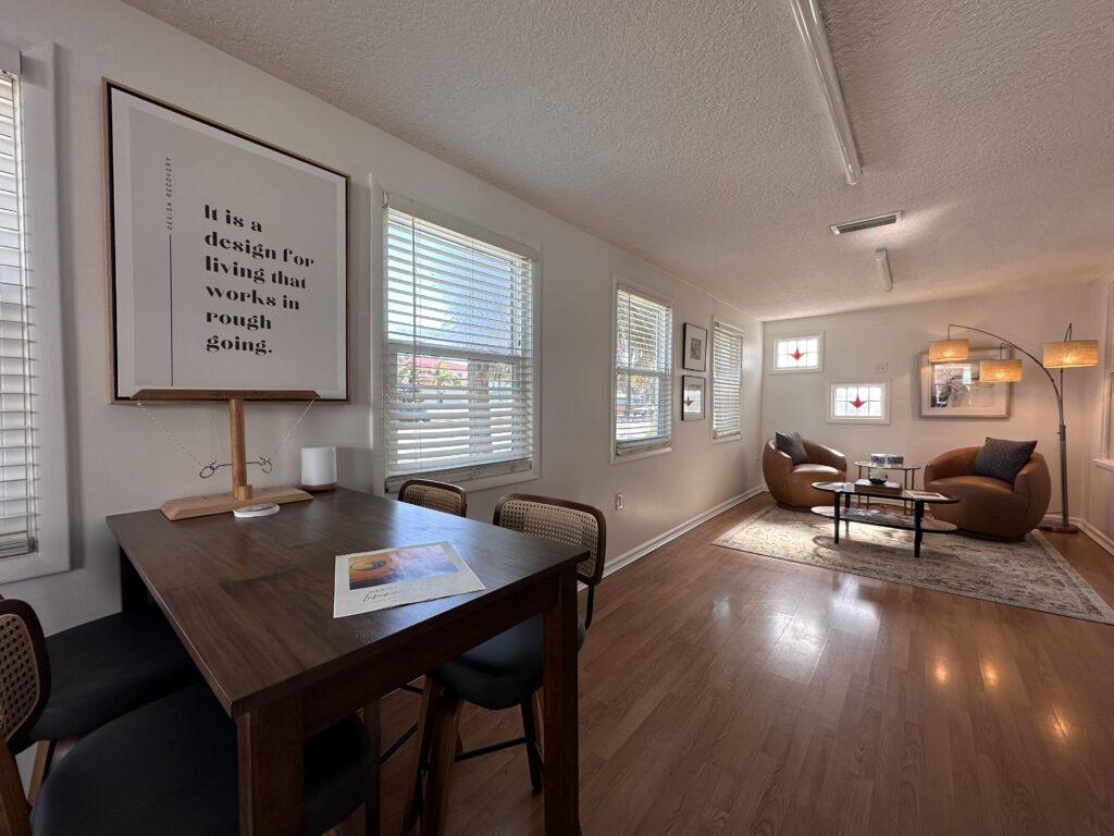 table and chairs with poster in background at Jacksonville addiction treatment center